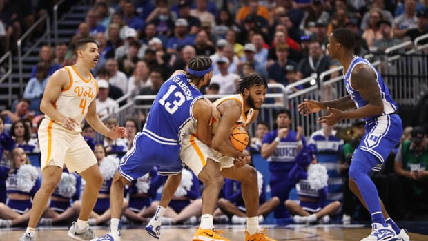 Tennessee Volunteers guard Josiah-Jordan James wrestles for the ball with Duke Blue Devils guard Jacob Grandison.